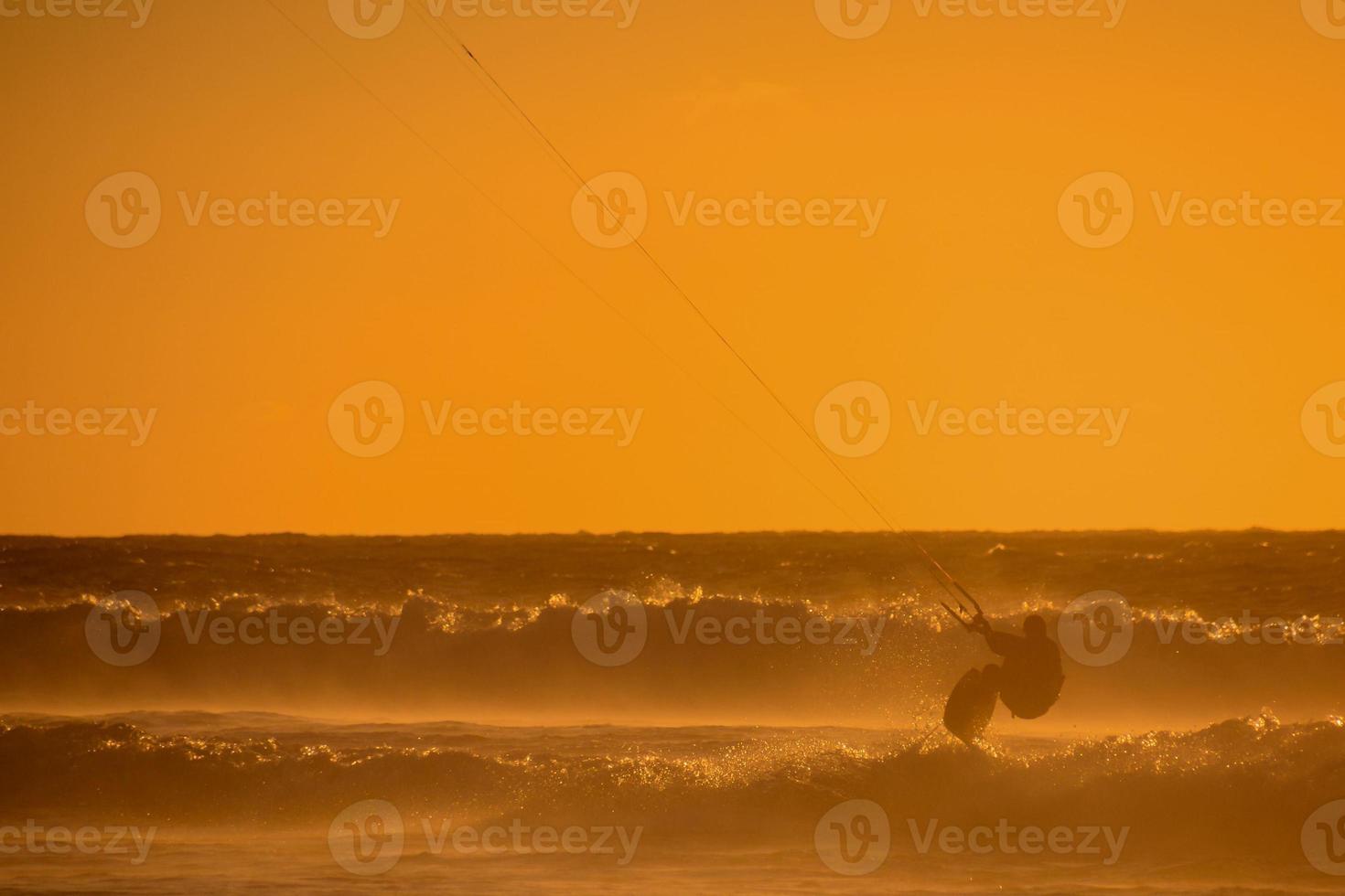 Kitesurfer at sunset photo
