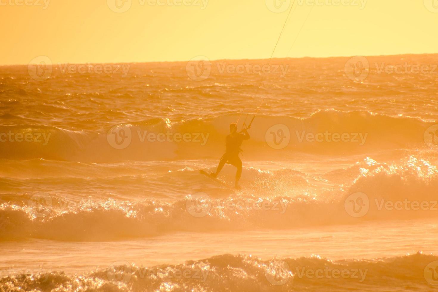 kitesurfer a puesta de sol foto