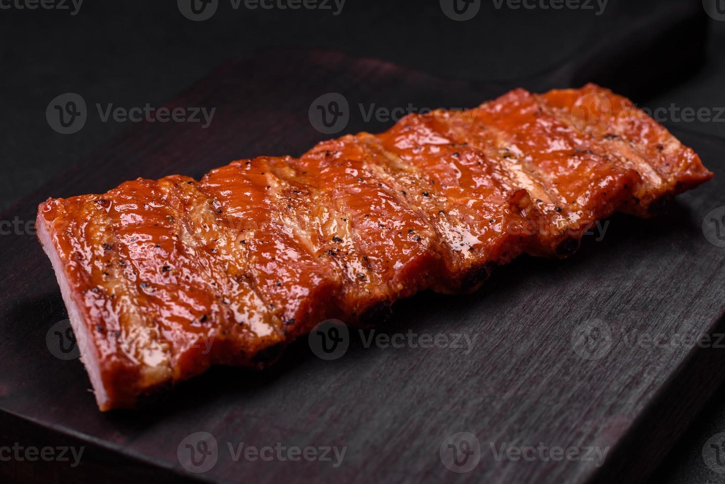 Delicious fresh grilled or smoked ribs with salt, spices and herbs photo