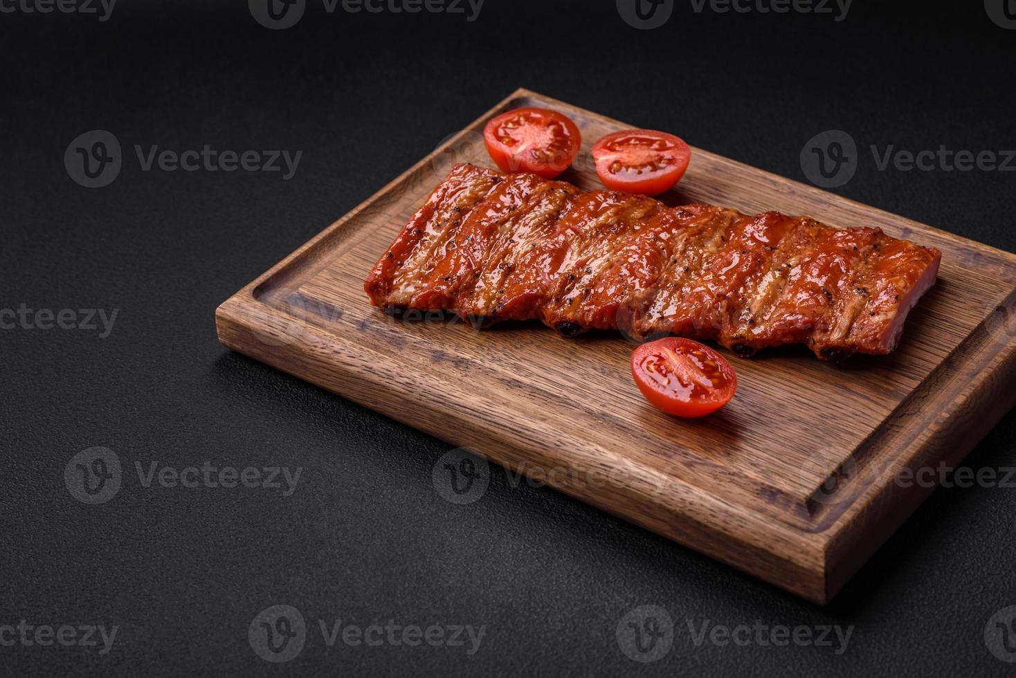 Delicious fresh grilled or smoked ribs with salt, spices and herbs photo