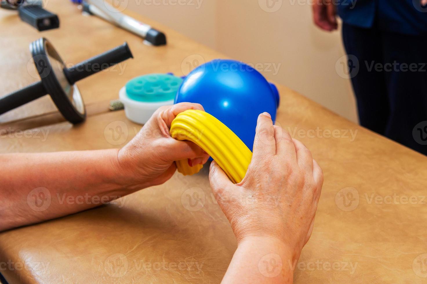 Working up with special phisiotherapic equipment in reabilitation center. photo