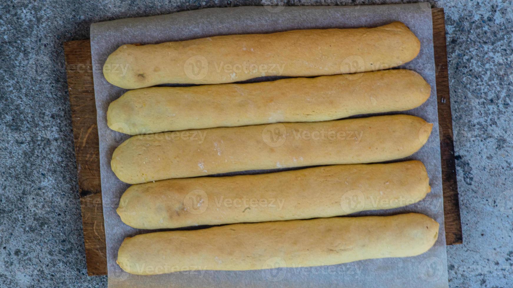 A plate of garlic bread sticks on the table. photo