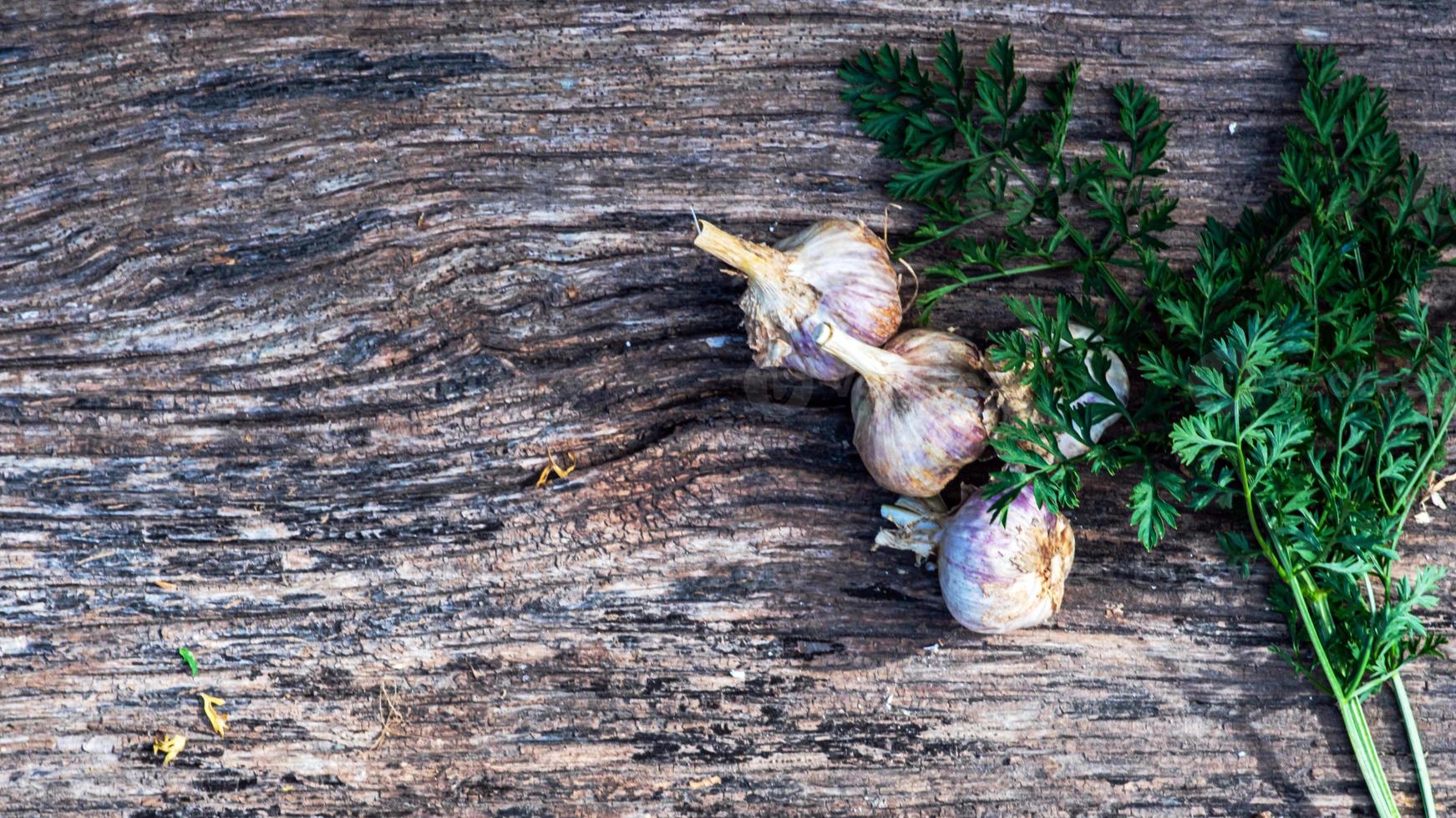Garlic cloves pile closeup. Garlic clove group on wood rustic table background side view photo