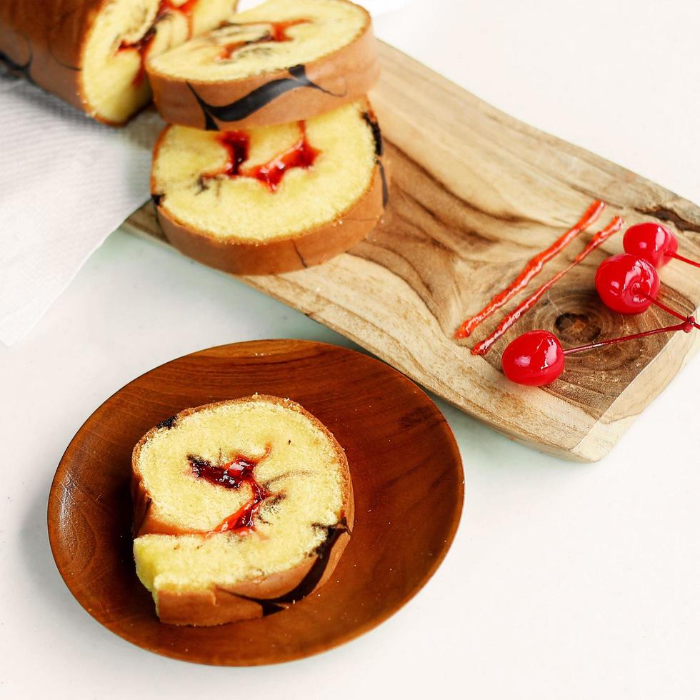 rolls cake with cherry jam filling photo