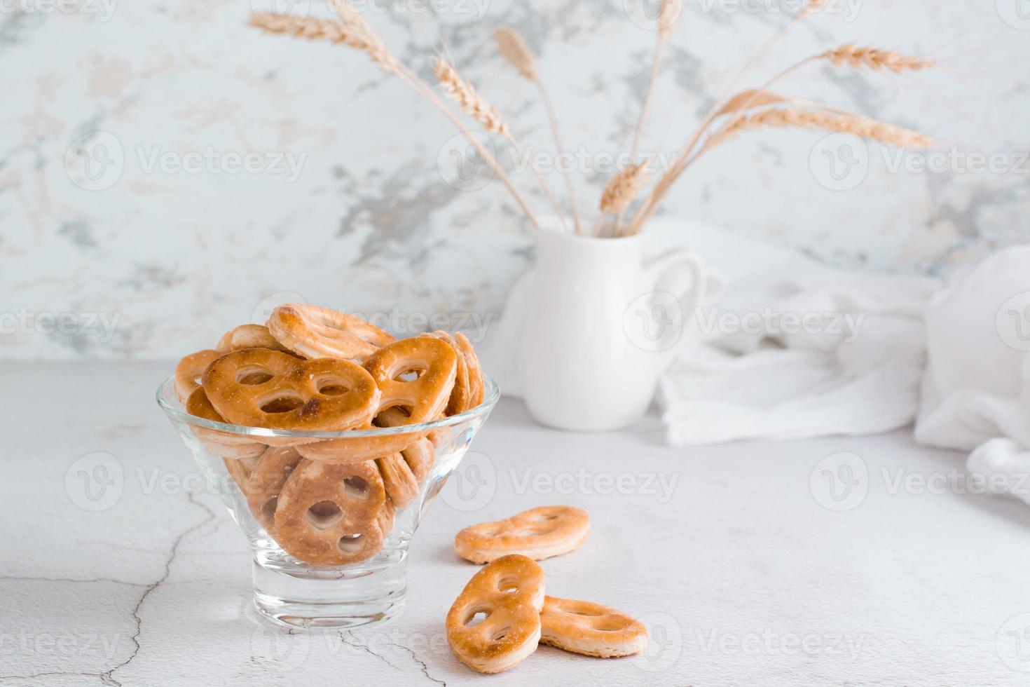 Bavarian pretzels in a glass bowl on the table. Snack for fast food photo