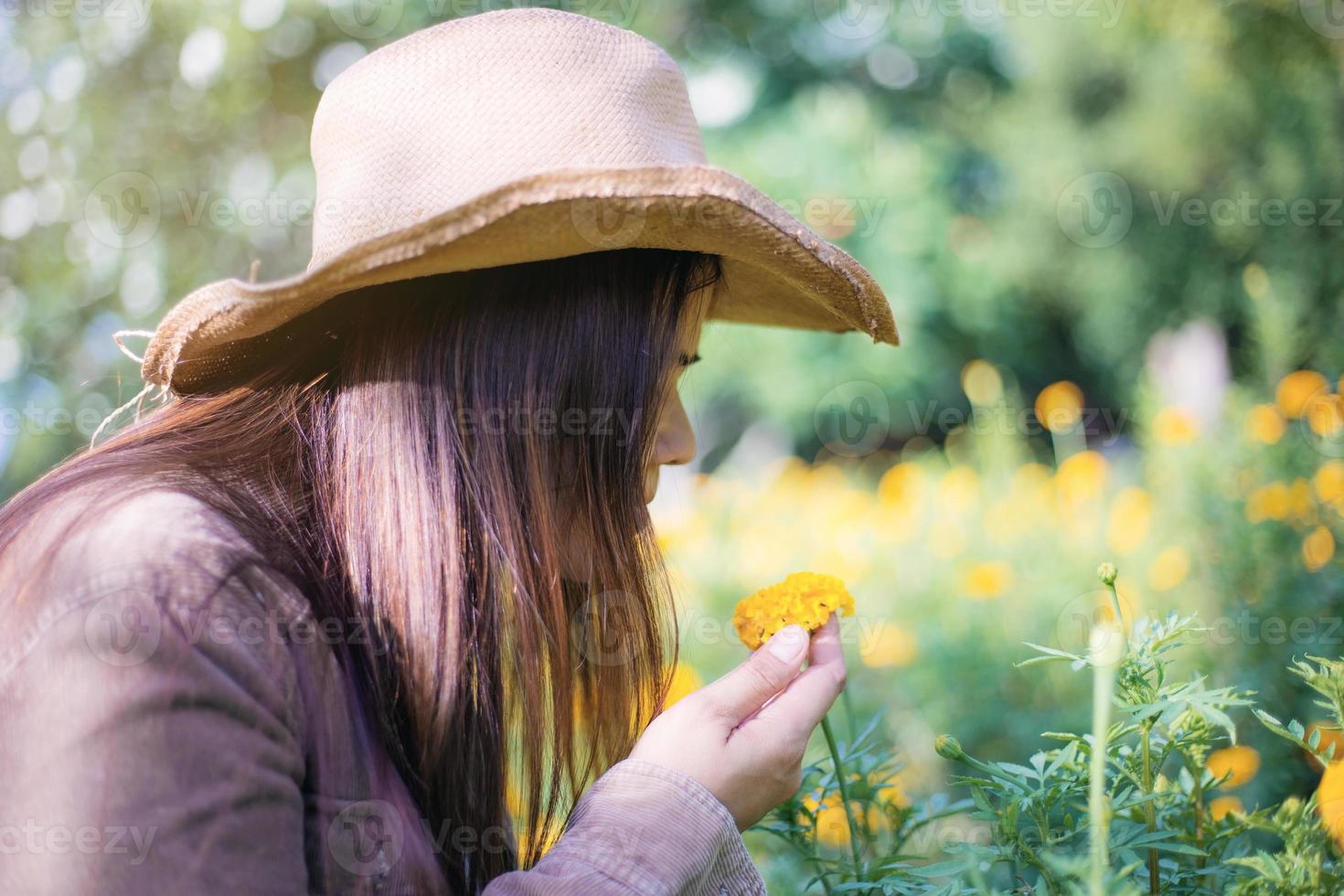 Woman and marigold flower in garden. photo