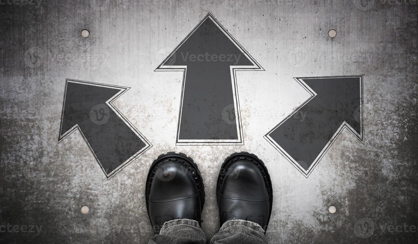 Heavy Black Leather Boots and Three Geometrical Arrows on Ground photo