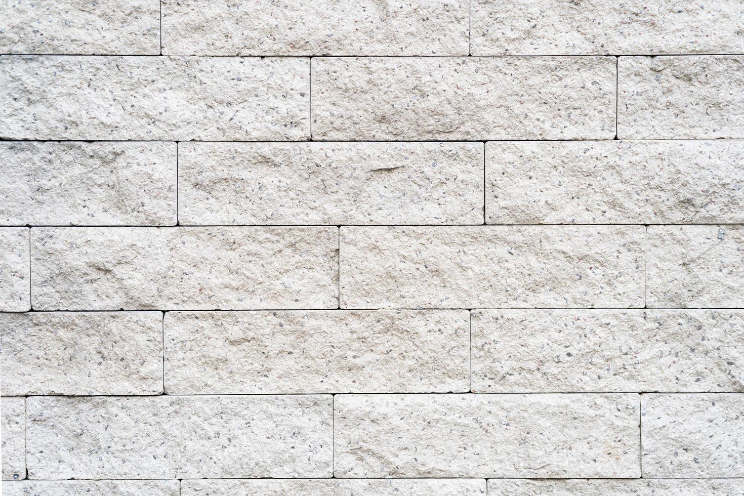 Cream and white brick wall texture background. Brickwork or stonework flooring interior rock old pattern clean concrete grid uneven bricks design stack. photo
