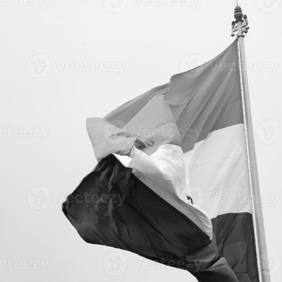 India flag flying high at Connaught Place with pride in blue sky, India flag fluttering, Indian Flag on Independence Day and Republic Day of India, tilt up shot, Waving Indian flag, Har Ghar Tiranga photo