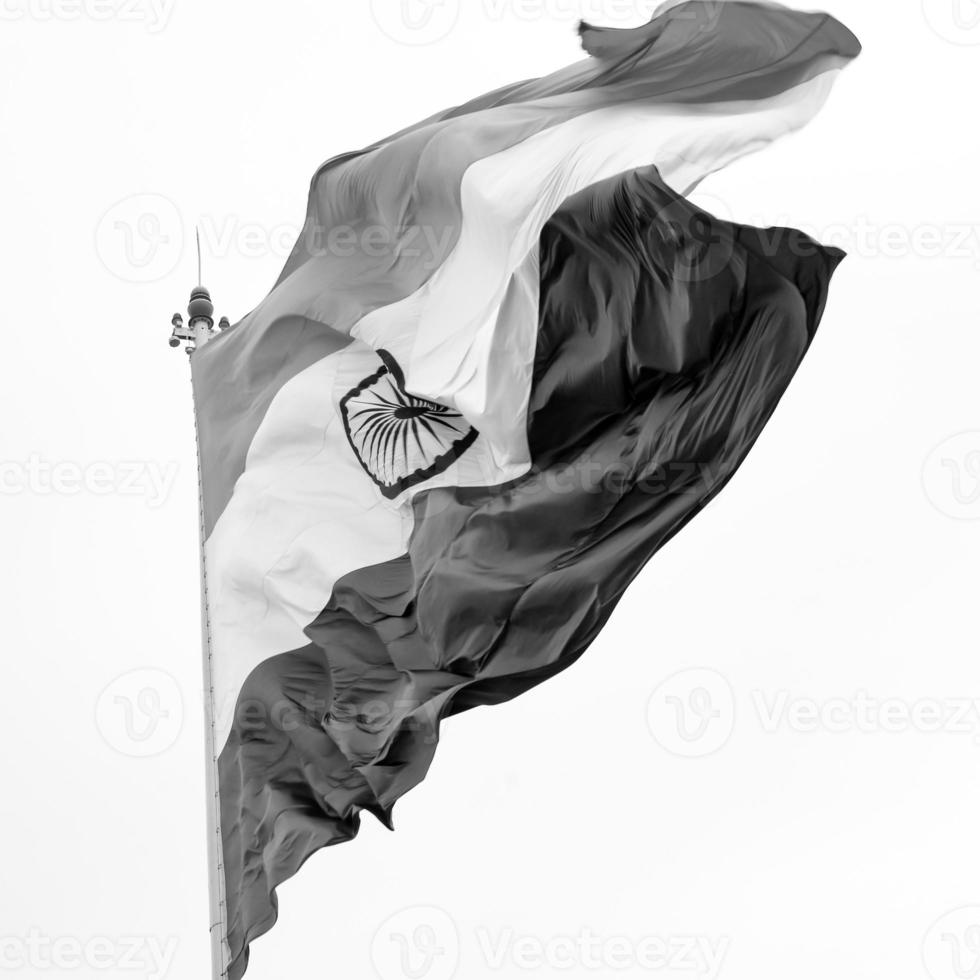 India flag flying high at Connaught Place with pride in blue sky, India flag fluttering, Indian Flag on Independence Day and Republic Day of India, tilt up shot, Waving Indian flag, Har Ghar Tiranga photo