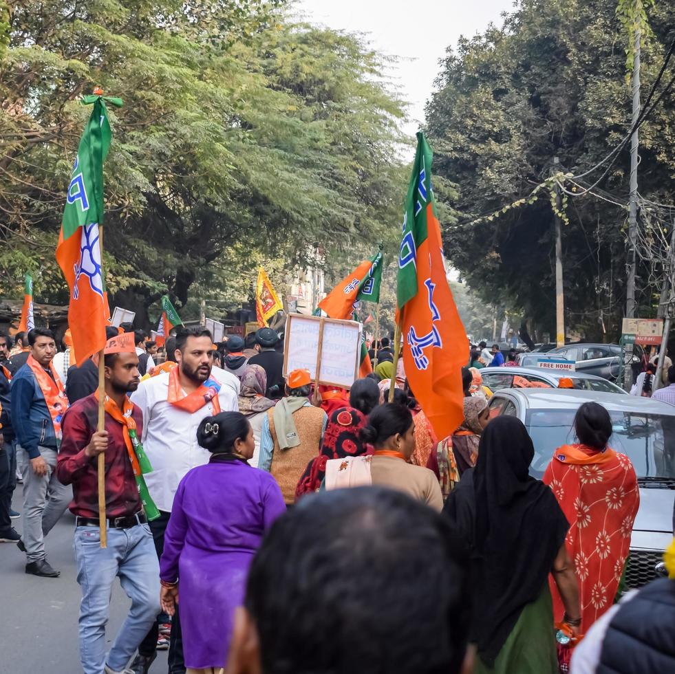 Delhi, India, December 02 2022 -Bharatiya Janata Party - BJP supporter during mega road show in support of BJP candidate Pankaj Luthara to file nomination papers ahead of MCD local body Elections 2022 photo