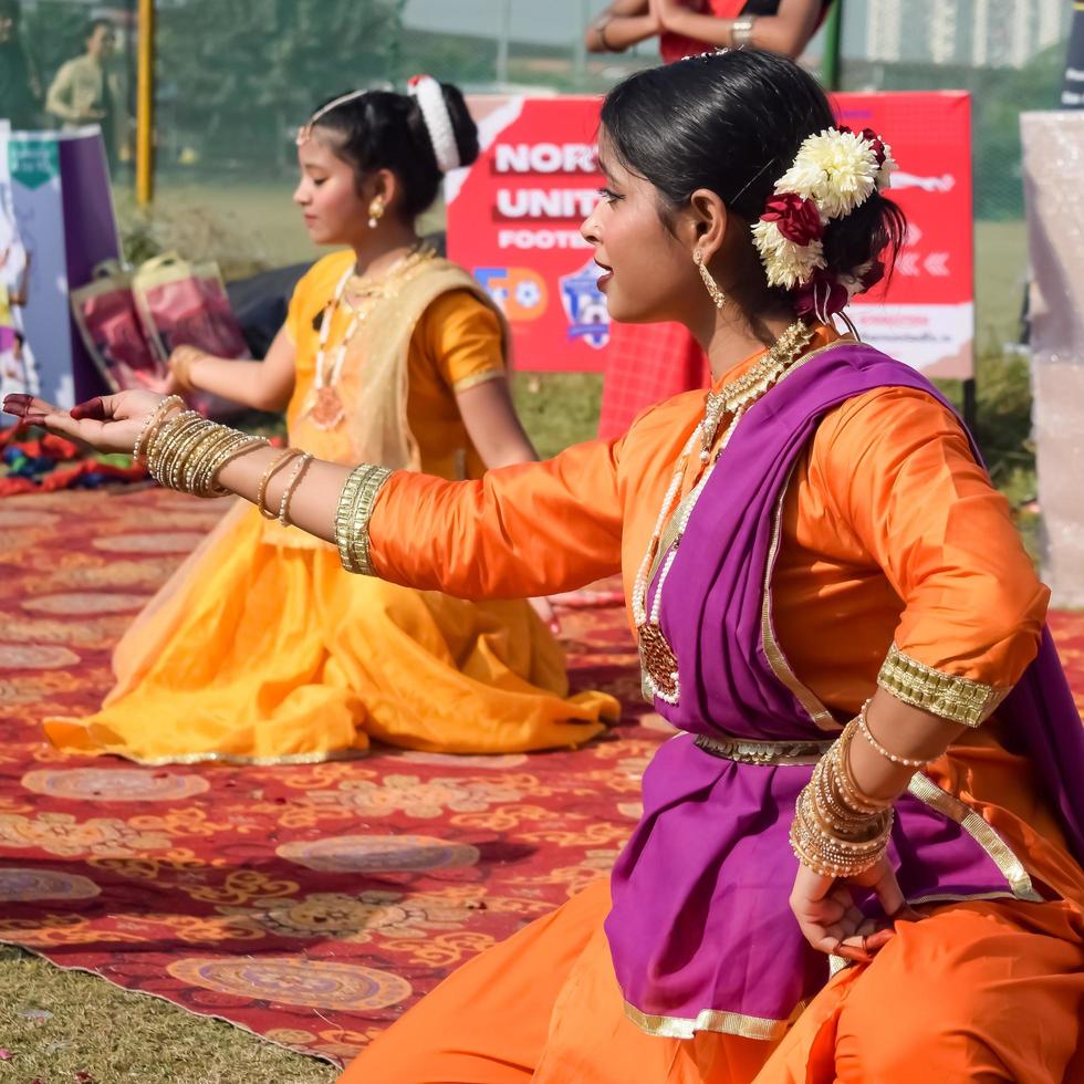 Delhi, India - December 11 2022 - Bharathanatyam Indian classical odissi dancers performing at stage. Beautiful Indian girl dancers in the posture of Indian dance. Indian classical dance Bharatanatyam photo