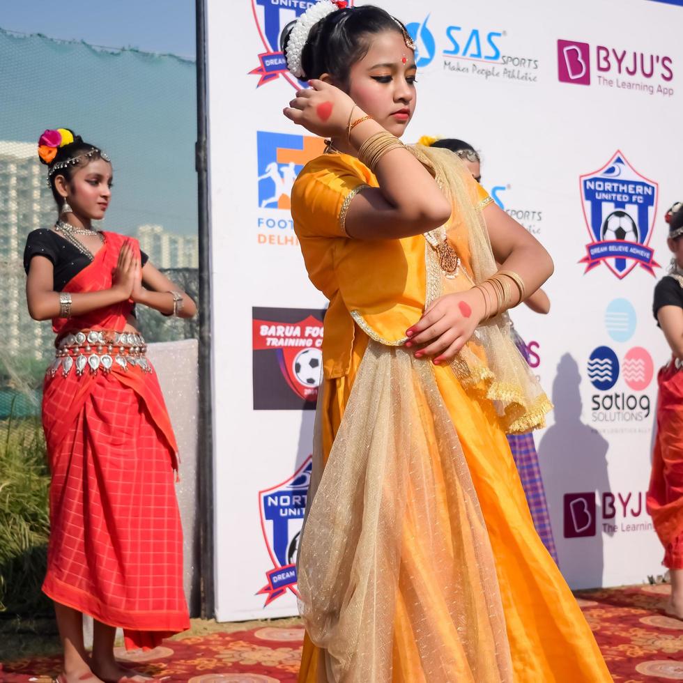 Delhi, India - December 11 2022 - Bharathanatyam Indian classical odissi dancers performing at stage. Beautiful Indian girl dancers in the posture of Indian dance. Indian classical dance Bharatanatyam photo