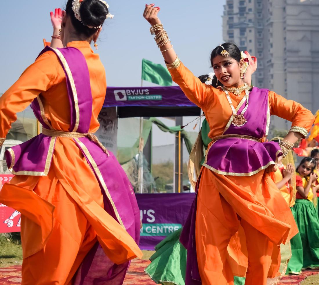 Delhi, India - December 11 2022 - Bharathanatyam Indian classical odissi dancers performing at stage. Beautiful Indian girl dancers in the posture of Indian dance. Indian classical dance Bharatanatyam photo