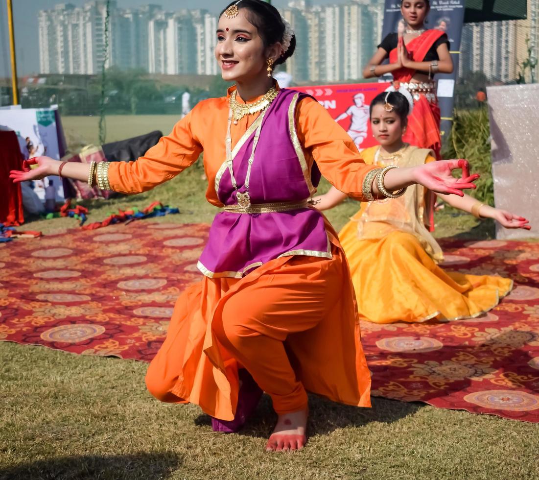 Delhi, India - December 11 2022 - Bharathanatyam Indian classical odissi dancers performing at stage. Beautiful Indian girl dancers in the posture of Indian dance. Indian classical dance Bharatanatyam photo