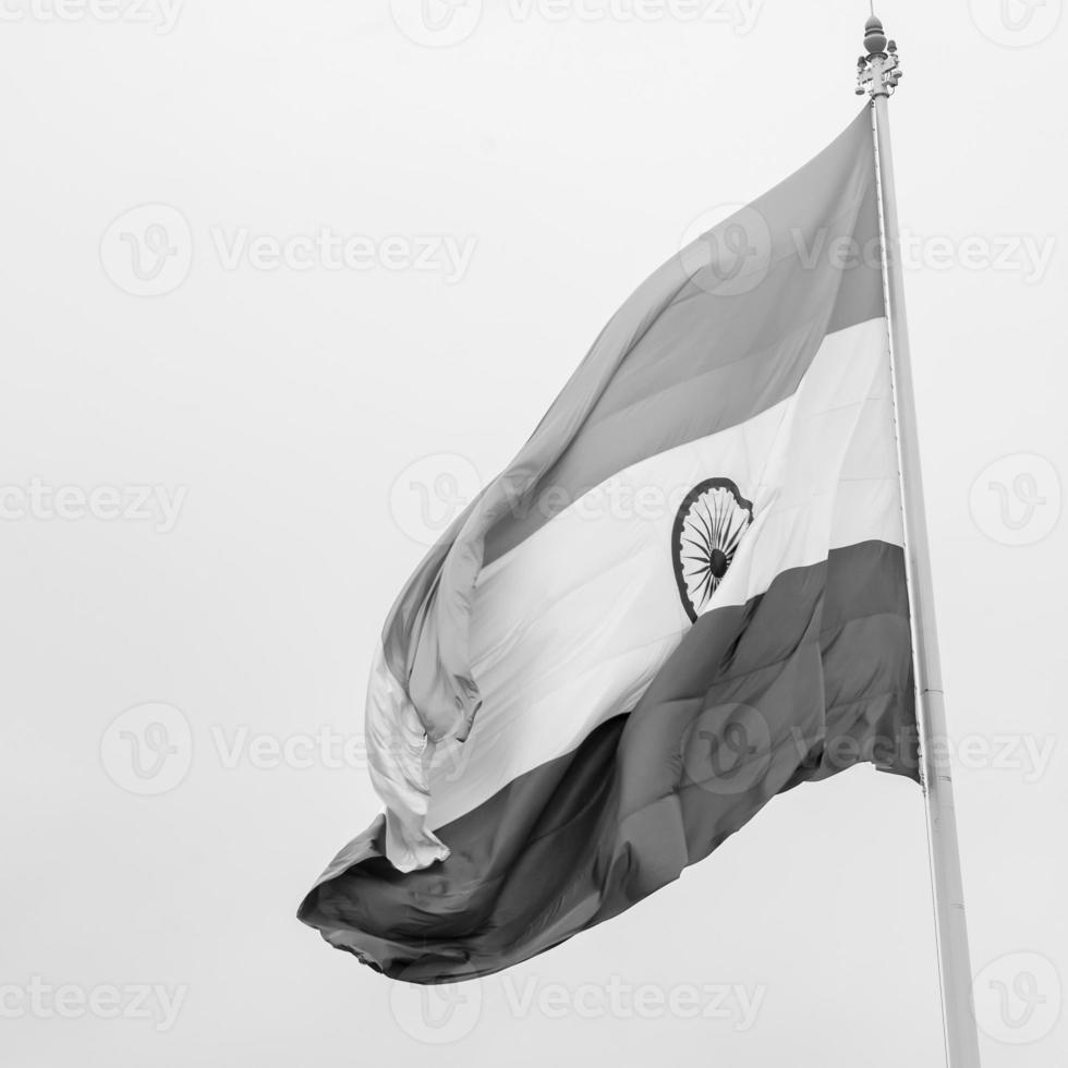 India flag flying high at Connaught Place with pride in blue sky, India flag fluttering, Indian Flag on Independence Day and Republic Day of India, tilt up shot, Waving Indian flag, Har Ghar Tiranga photo