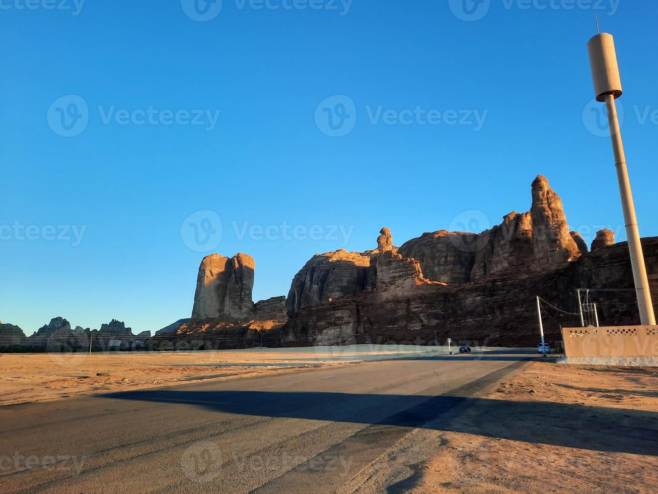 A beautiful daytime view of a winter park in Al Ula, Saudi Arabia. The park is surrounded by ancient hills. photo