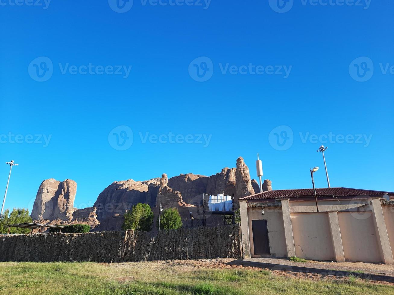 A beautiful daytime view of a winter park in Al Ula, Saudi Arabia. The park is surrounded by ancient hills. photo