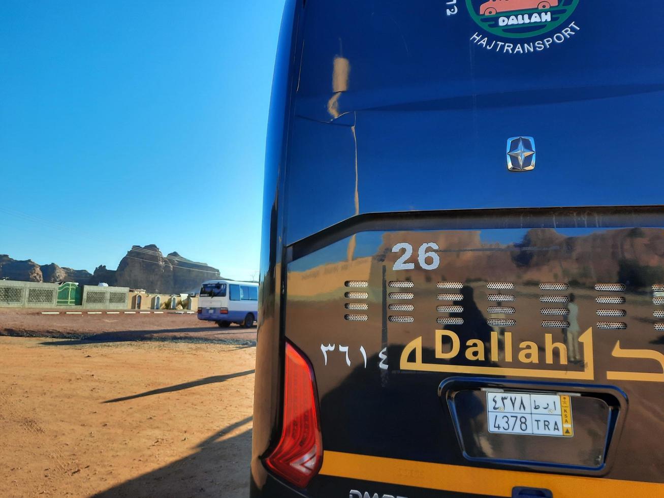 Al Ula, Saudi Arabia, March 2023 - Buses are parked at different places in the desert to take tourists to different places during the day in Al Ula, Saudi Arabia. photo