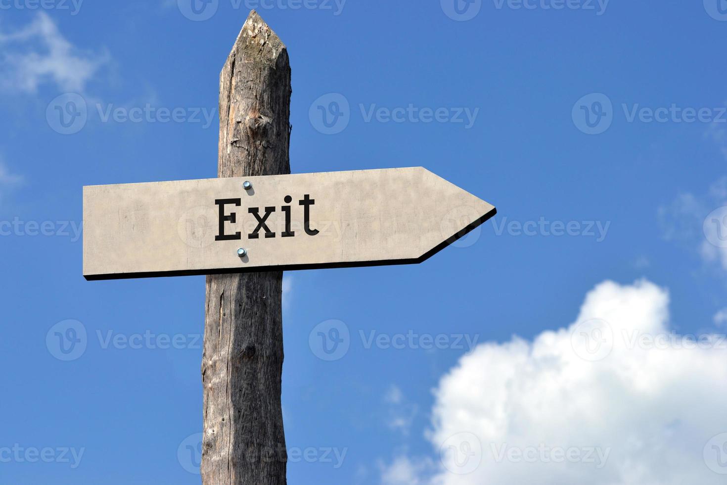 Exit - Wooden Signpost with one Arrow, Sky with Clouds photo