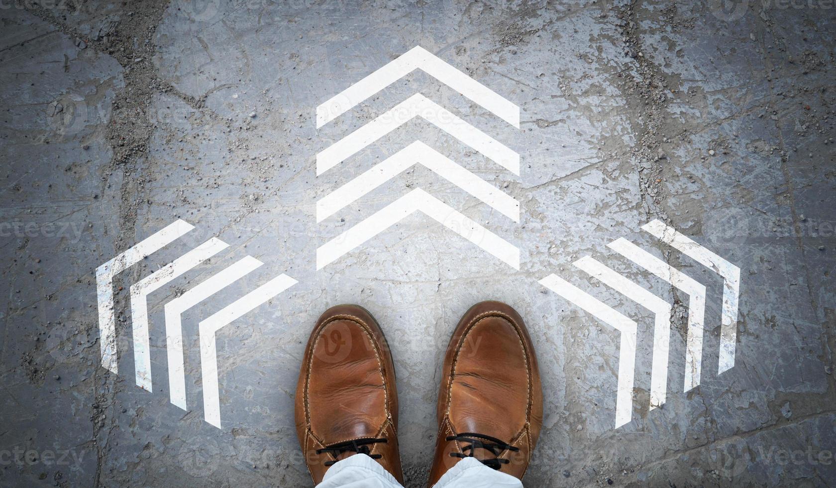 Brown Leather Shoes and Three Chalky Arrows on Asphalt - Decision Concept photo