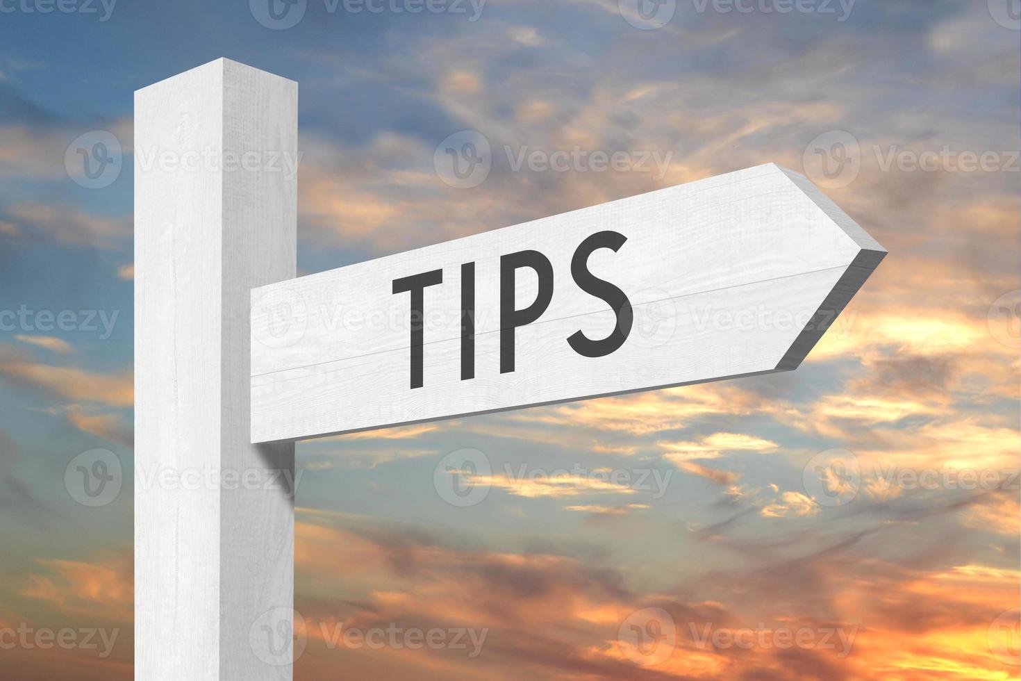 Tips - White Wooden Signpost with one Arrow and Sunset Sky in Background photo