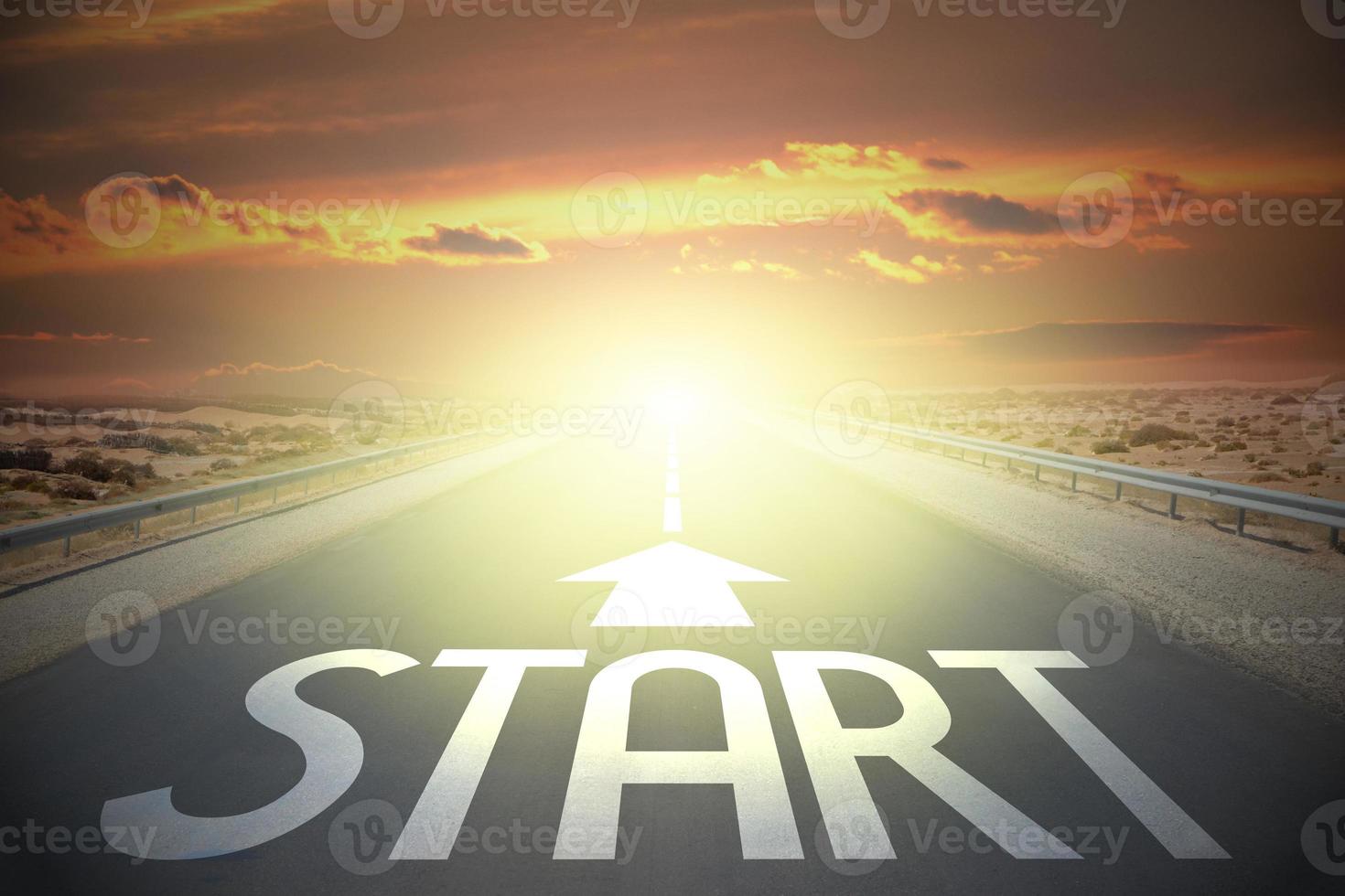 Start word and arrow on a road and sunset sky - beginning concept photo