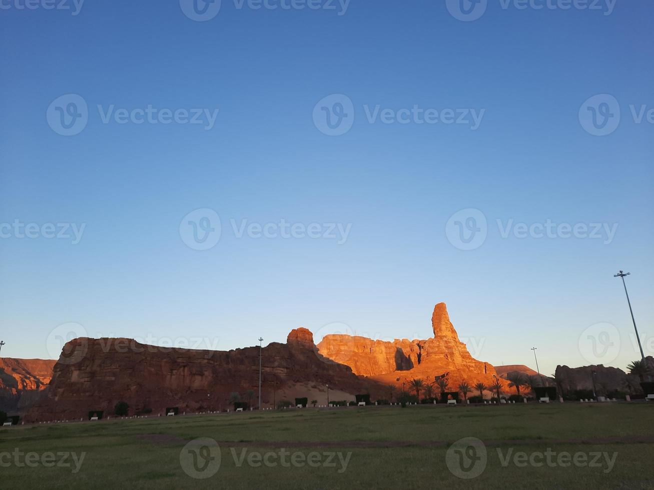 A beautiful daytime view of a winter park in Al Ula, Saudi Arabia. The park is surrounded by ancient hills. photo