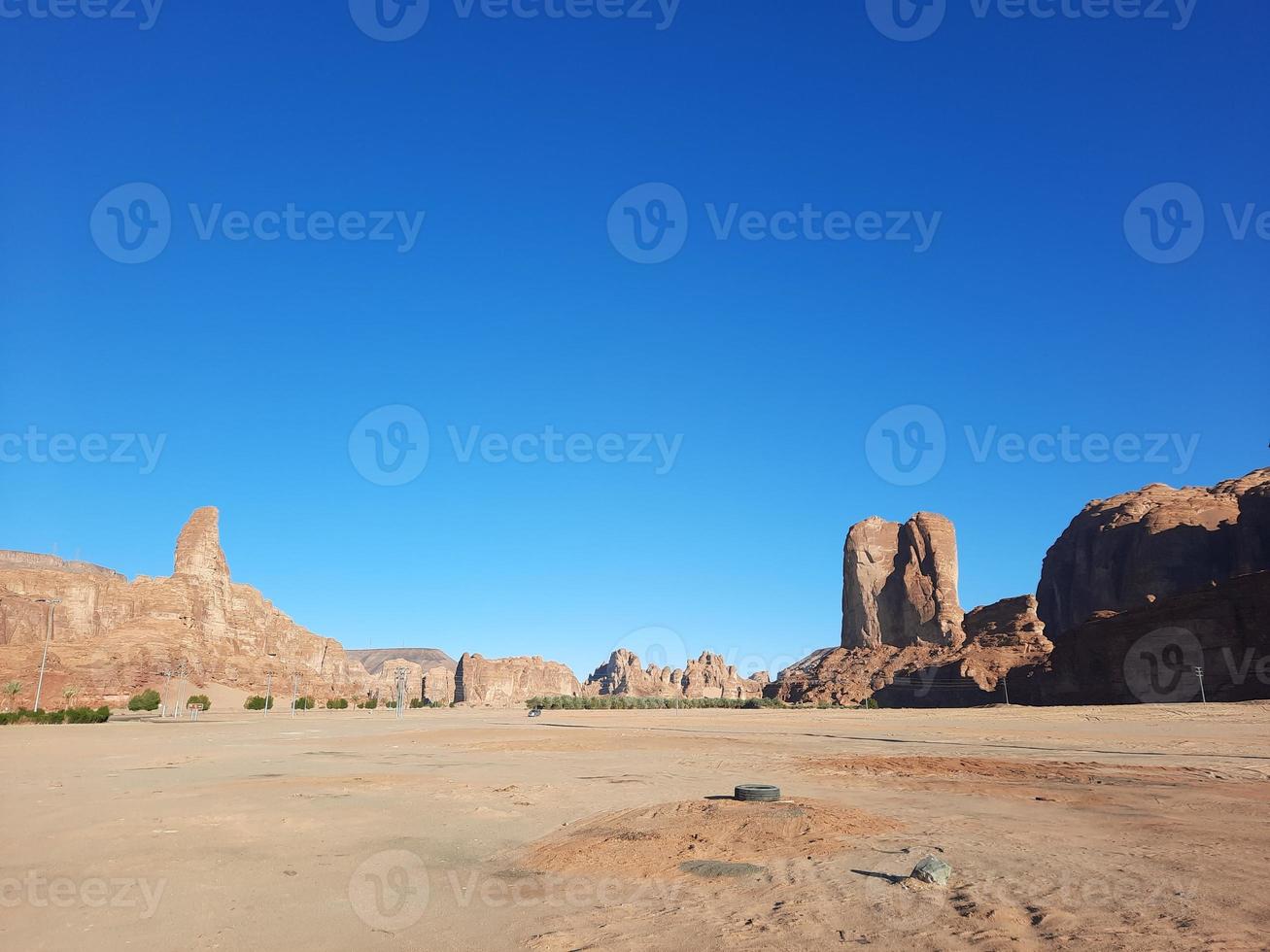 A beautiful daytime view of a winter park in Al Ula, Saudi Arabia. The park is surrounded by ancient hills. photo