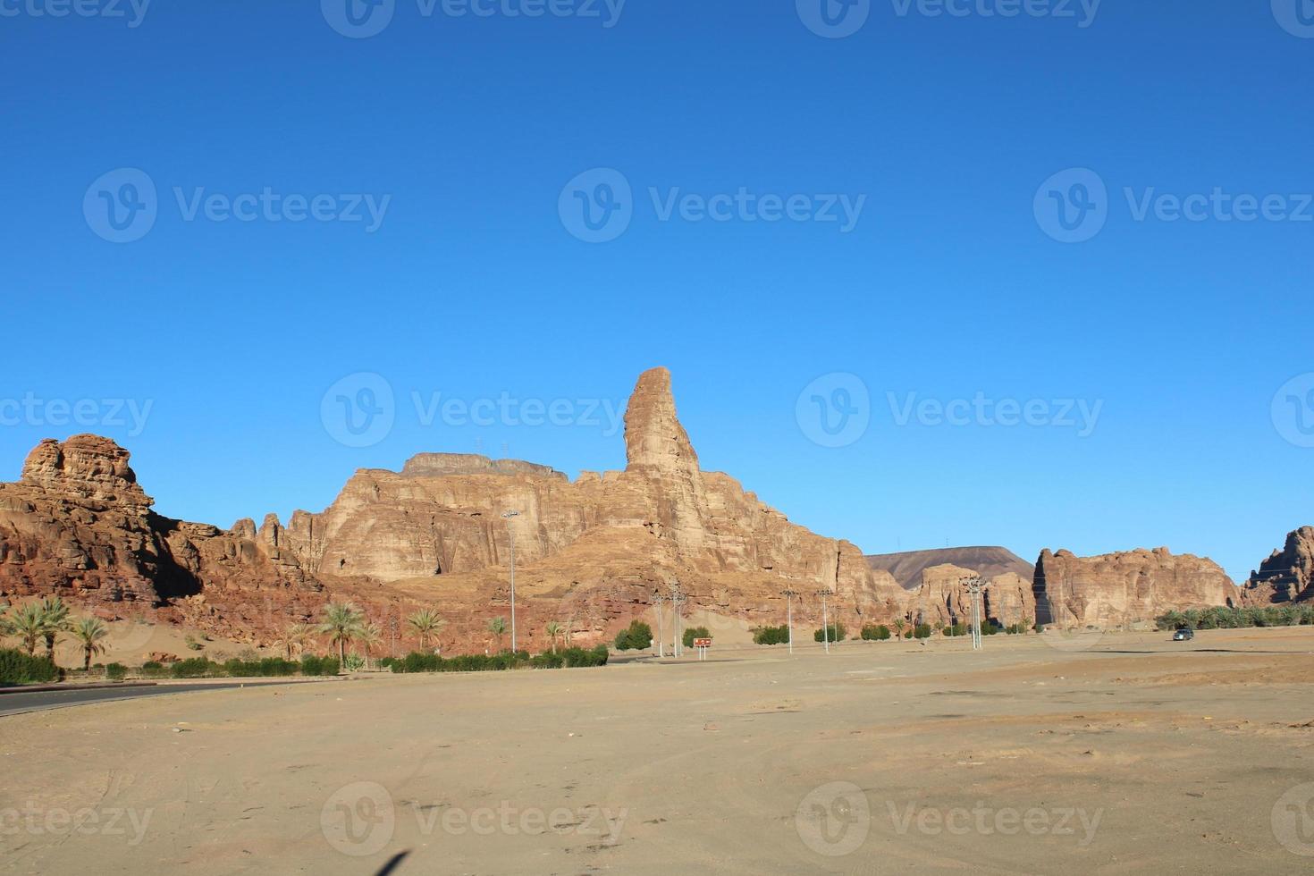 A beautiful daytime view of a winter park in Al Ula, Saudi Arabia. The park is surrounded by ancient hills. photo