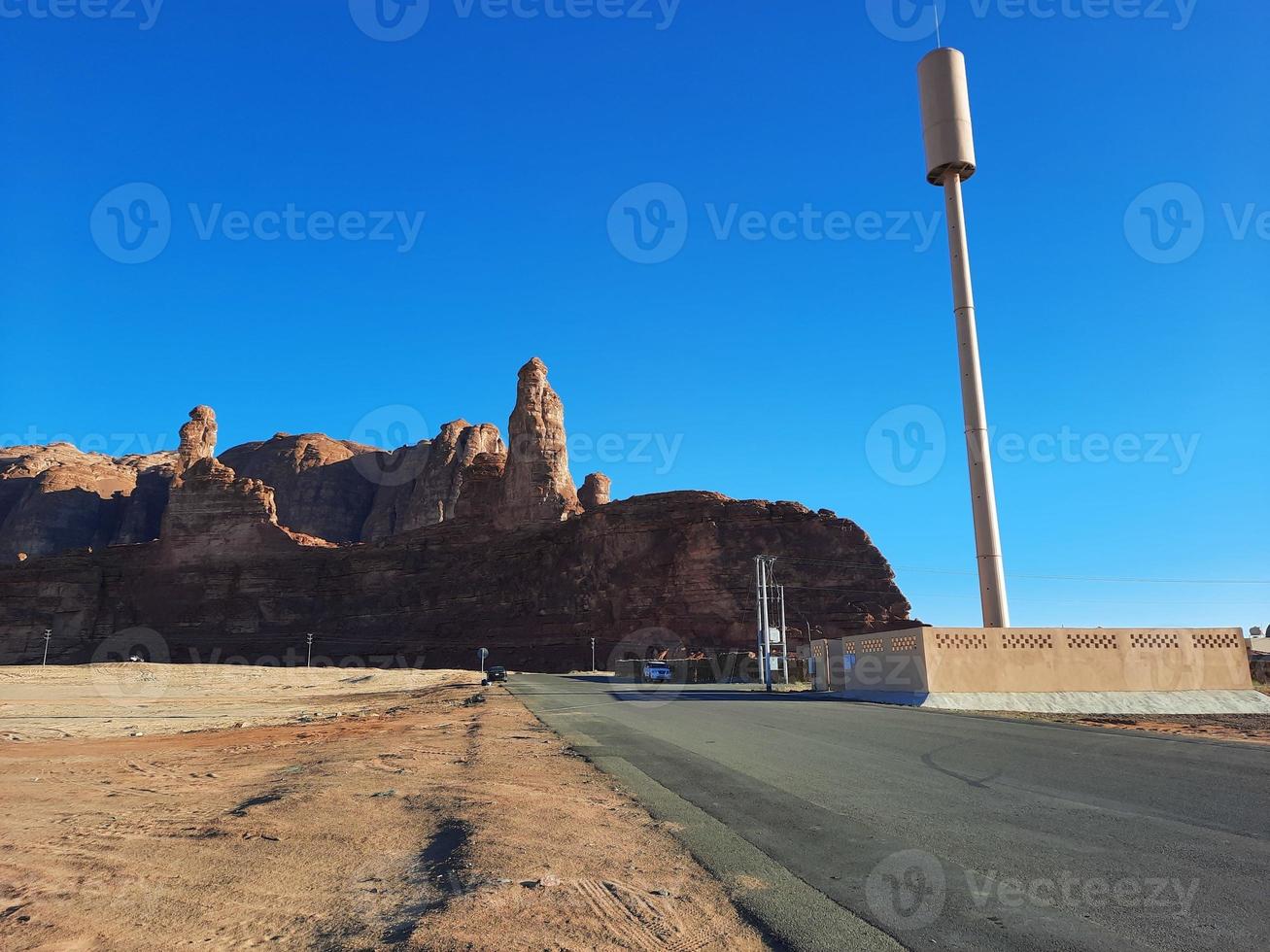 A beautiful daytime view of a winter park in Al Ula, Saudi Arabia. The park is surrounded by ancient hills. photo