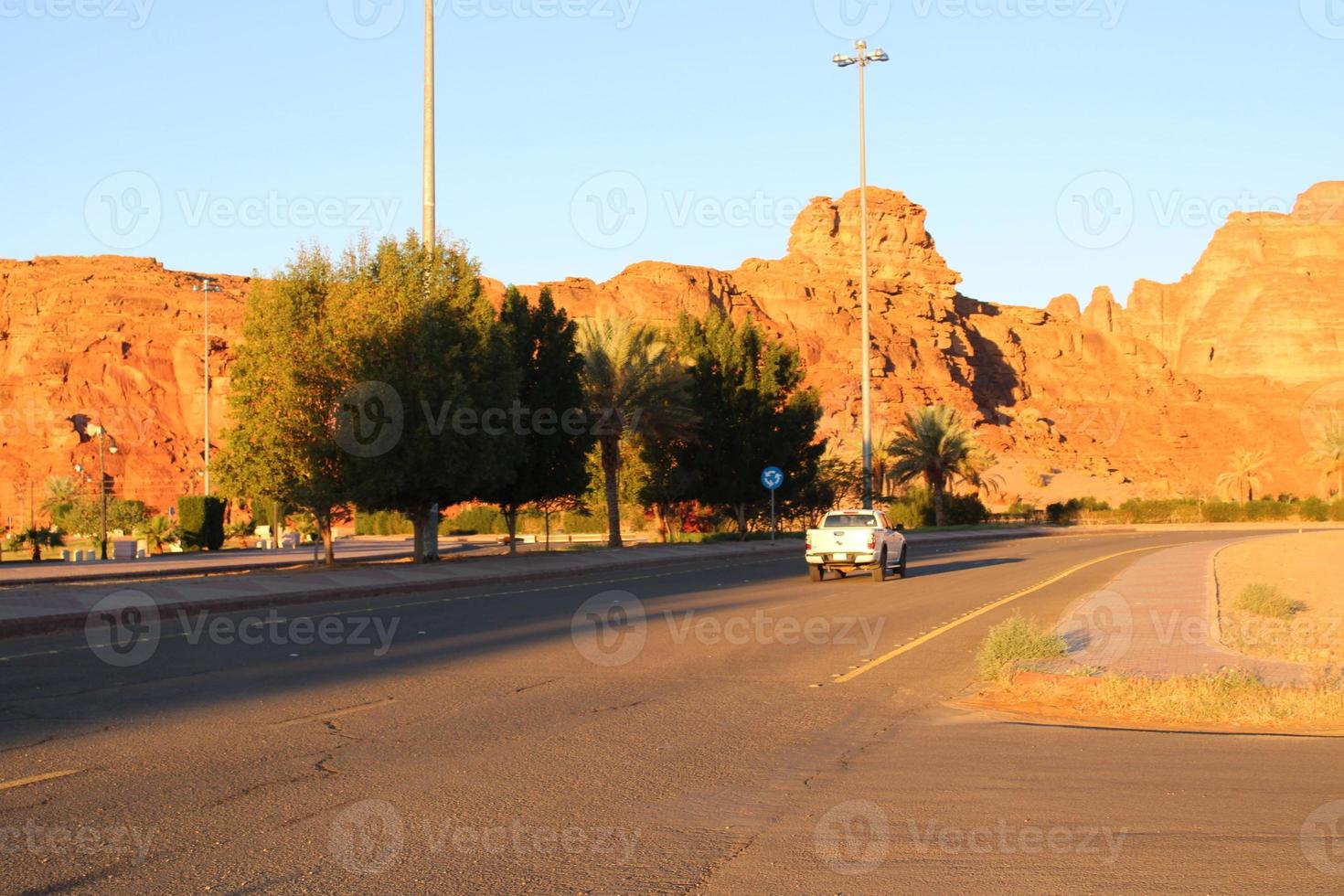 A beautiful daytime view of a winter park in Al Ula, Saudi Arabia. The park is surrounded by ancient hills. photo