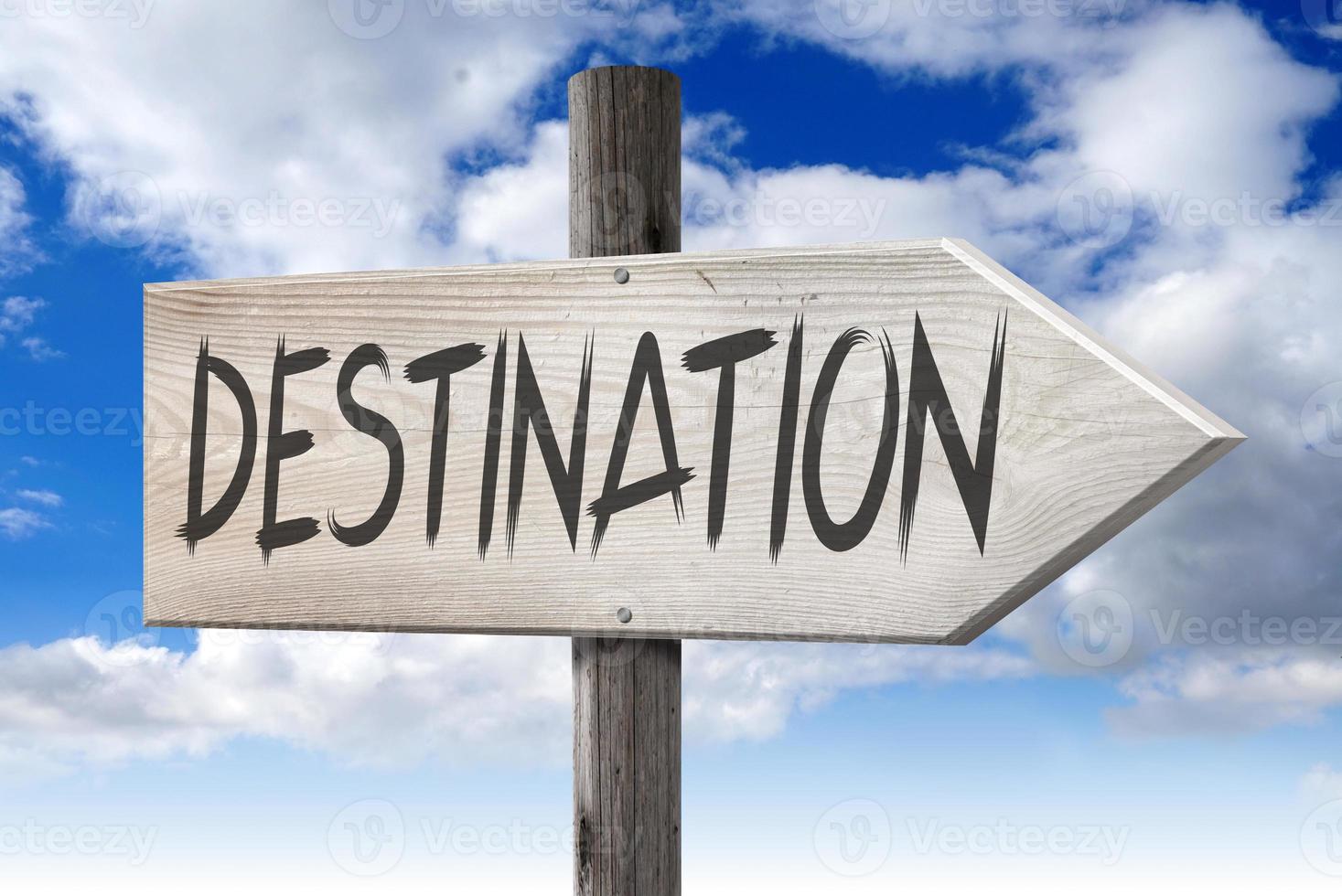 Destination - Wooden Signpost with one Arrow and Cloudy Sky in Background photo