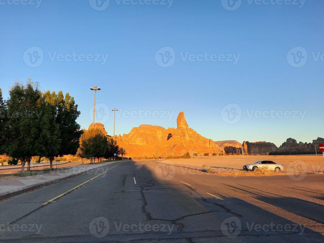 A beautiful daytime view of a winter park in Al Ula, Saudi Arabia. The park is surrounded by ancient hills. photo