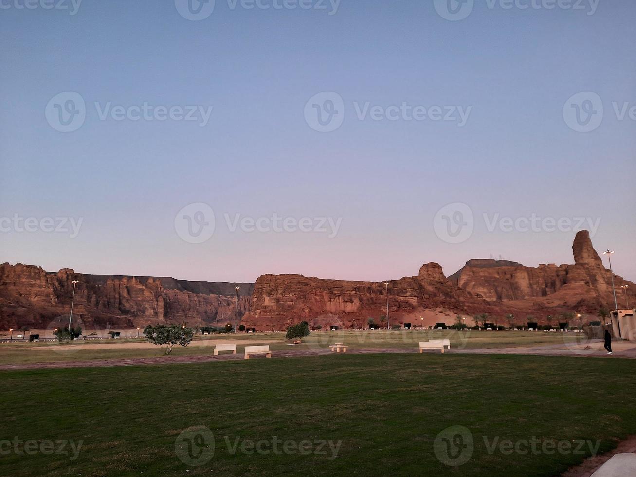 A beautiful daytime view of a winter park in Al Ula, Saudi Arabia. The park is surrounded by ancient hills. photo