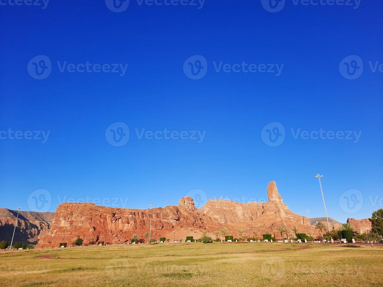 A beautiful daytime view of a winter park in Al Ula, Saudi Arabia. The park is surrounded by ancient hills. photo