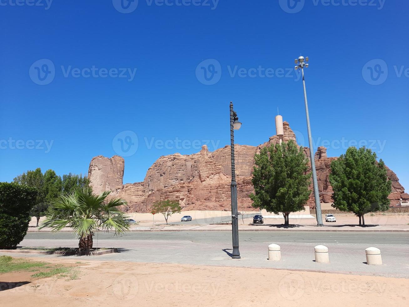 A beautiful daytime view of a winter park in Al Ula, Saudi Arabia. The park is surrounded by ancient hills. photo