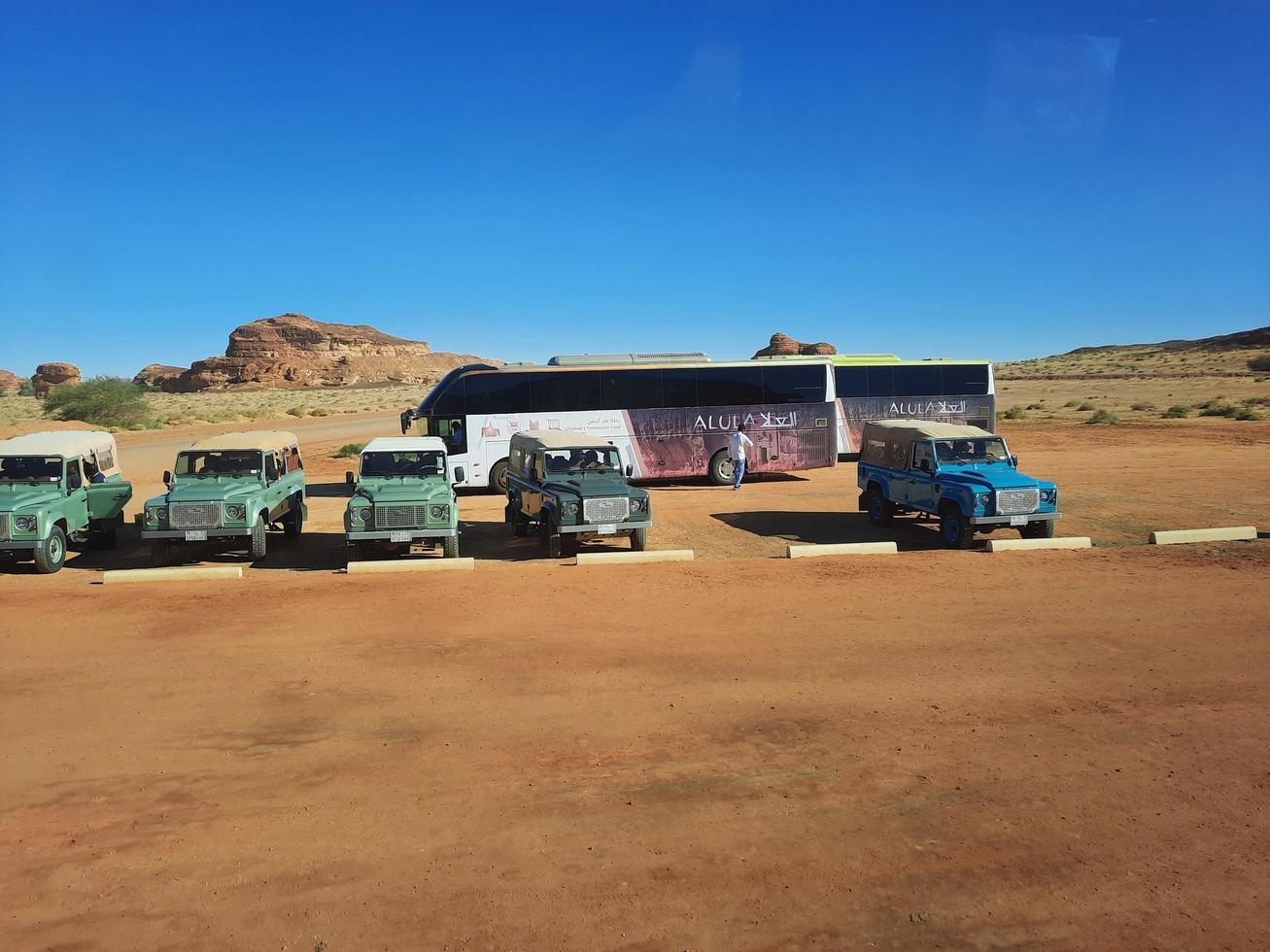 Al Ula, Saudi Arabia, March 2023 - Jeeps are parked at different places in the desert to take tourists to different places during the day in Al Ula, Saudi Arabia. photo