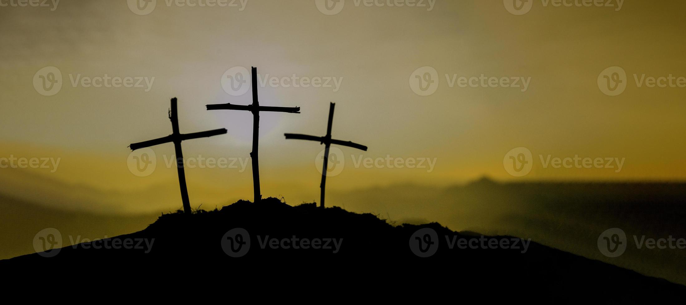 Crucifixion Of Jesus Christ - Cross At Sunset. The concept of the resurrection of Jesus in Christianity. Crucifixion on Calvary or Golgotha hills in holy bible. photo