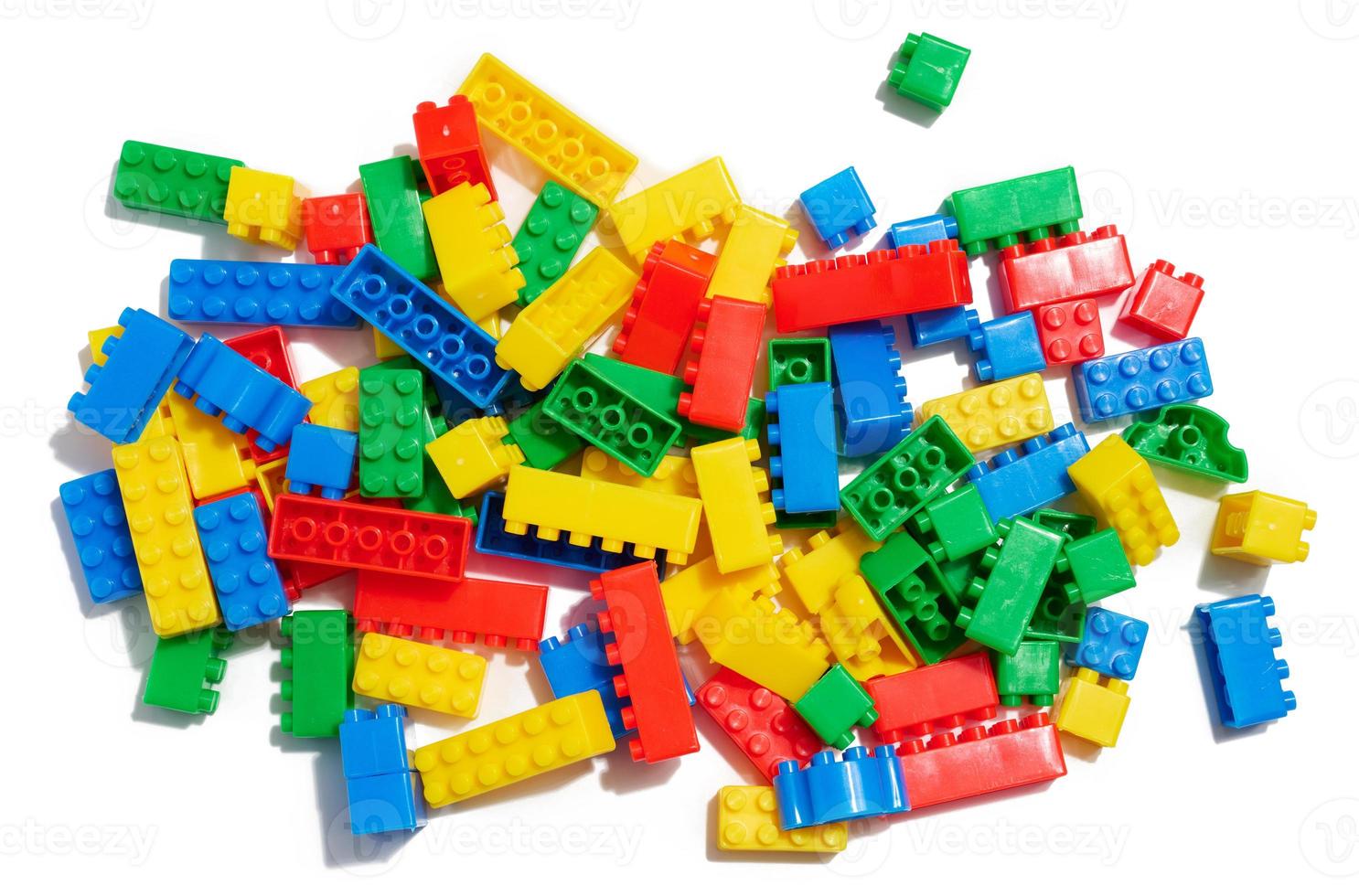 Multi-colored plastic cubes of a children's designer on a white isolated background, top view photo