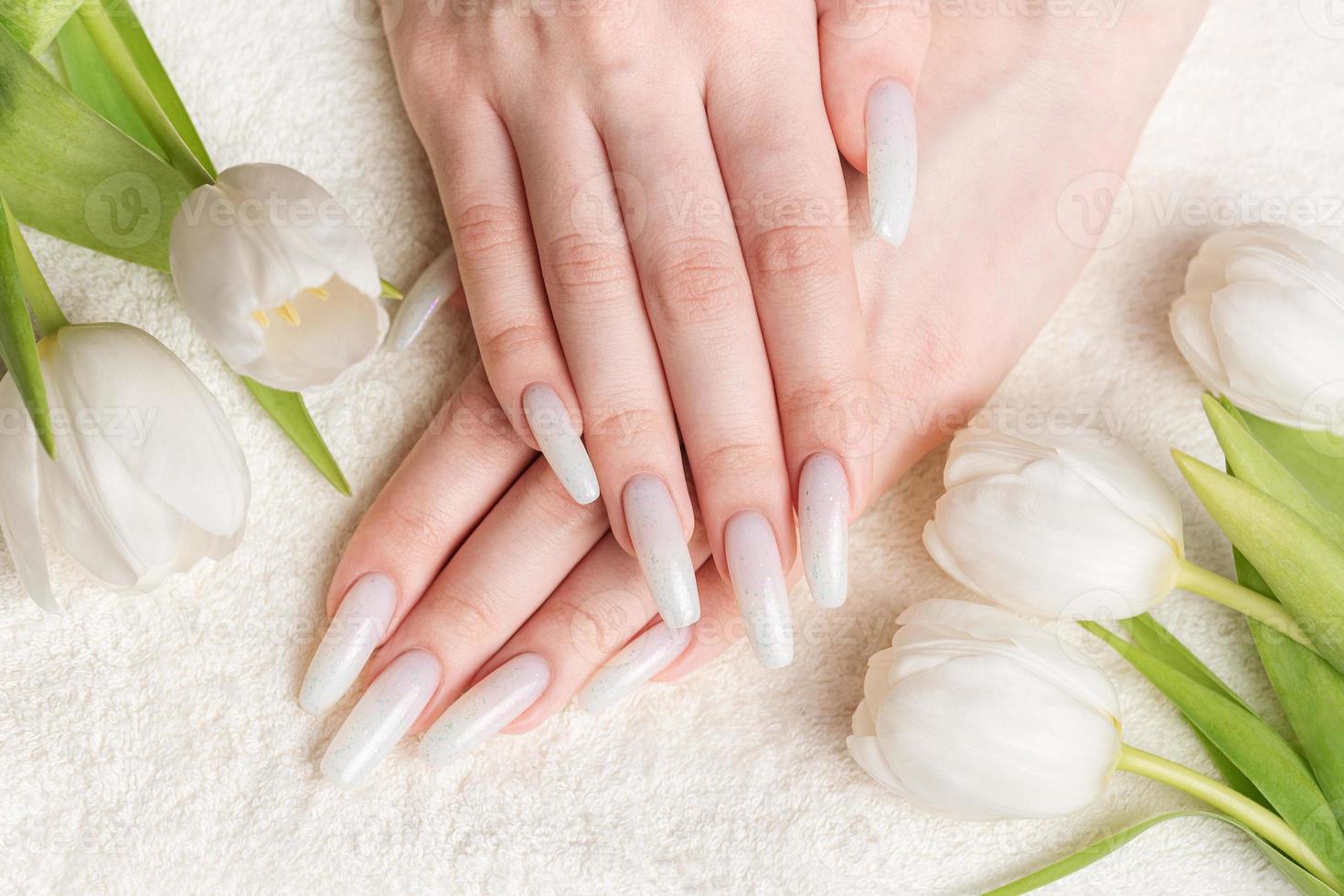 Female hand with spring nail design. photo