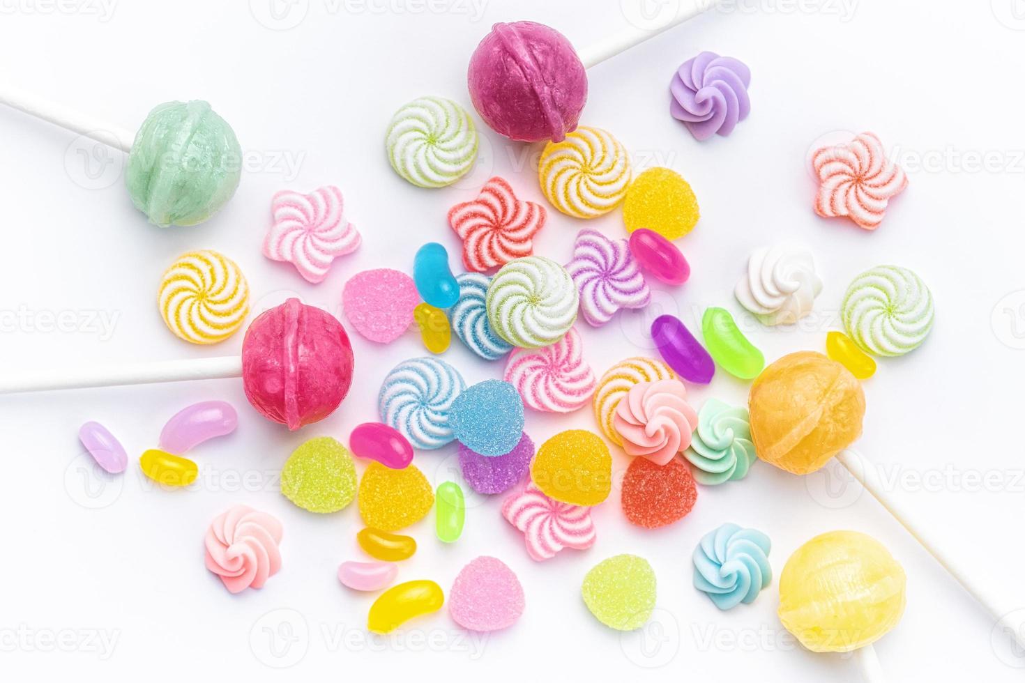 Sweet lollipops and candies on white background photo