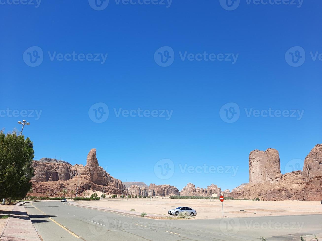 A beautiful daytime view of a winter park in Al Ula, Saudi Arabia. The park is surrounded by ancient hills. photo