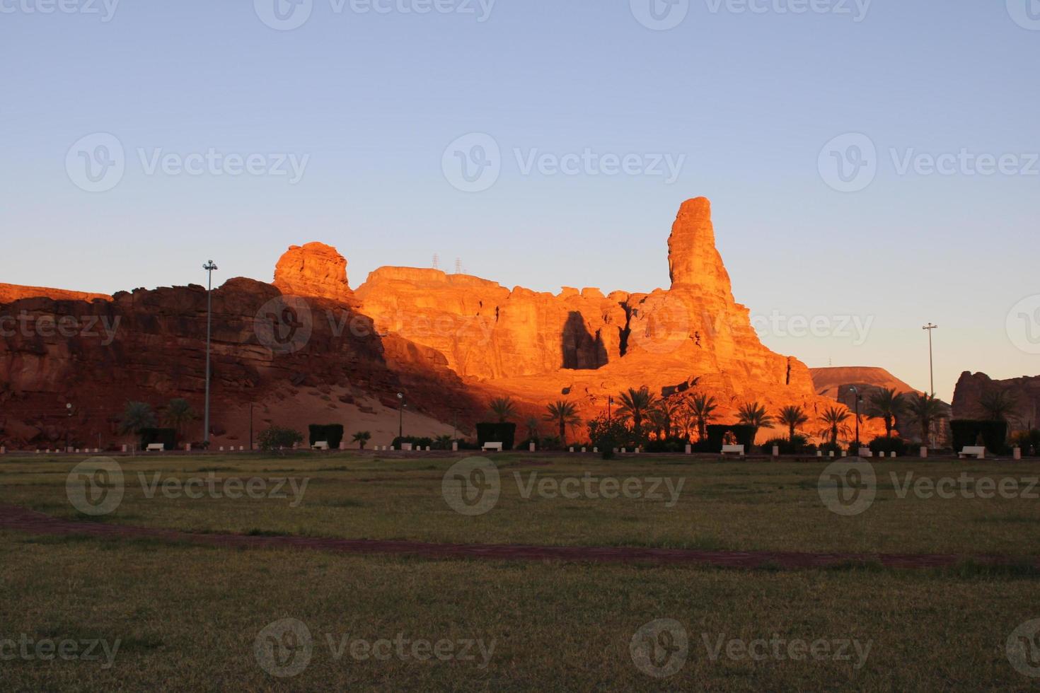 A beautiful daytime view of a winter park in Al Ula, Saudi Arabia. The park is surrounded by ancient hills. photo