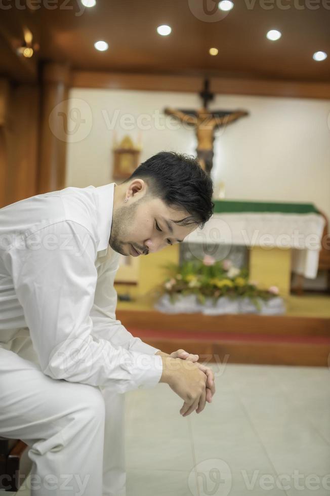 Christian man asking for blessings from God,Asian man praying to Jesus Christ photo
