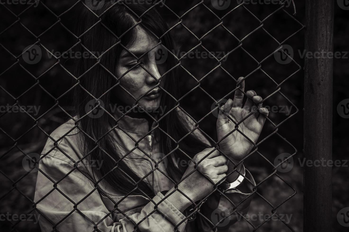 Portrait of women desperate to catch the iron prison,prisoner concept,thailand people,Hope to be free,If the violate the law would be arrested and jailed. photo