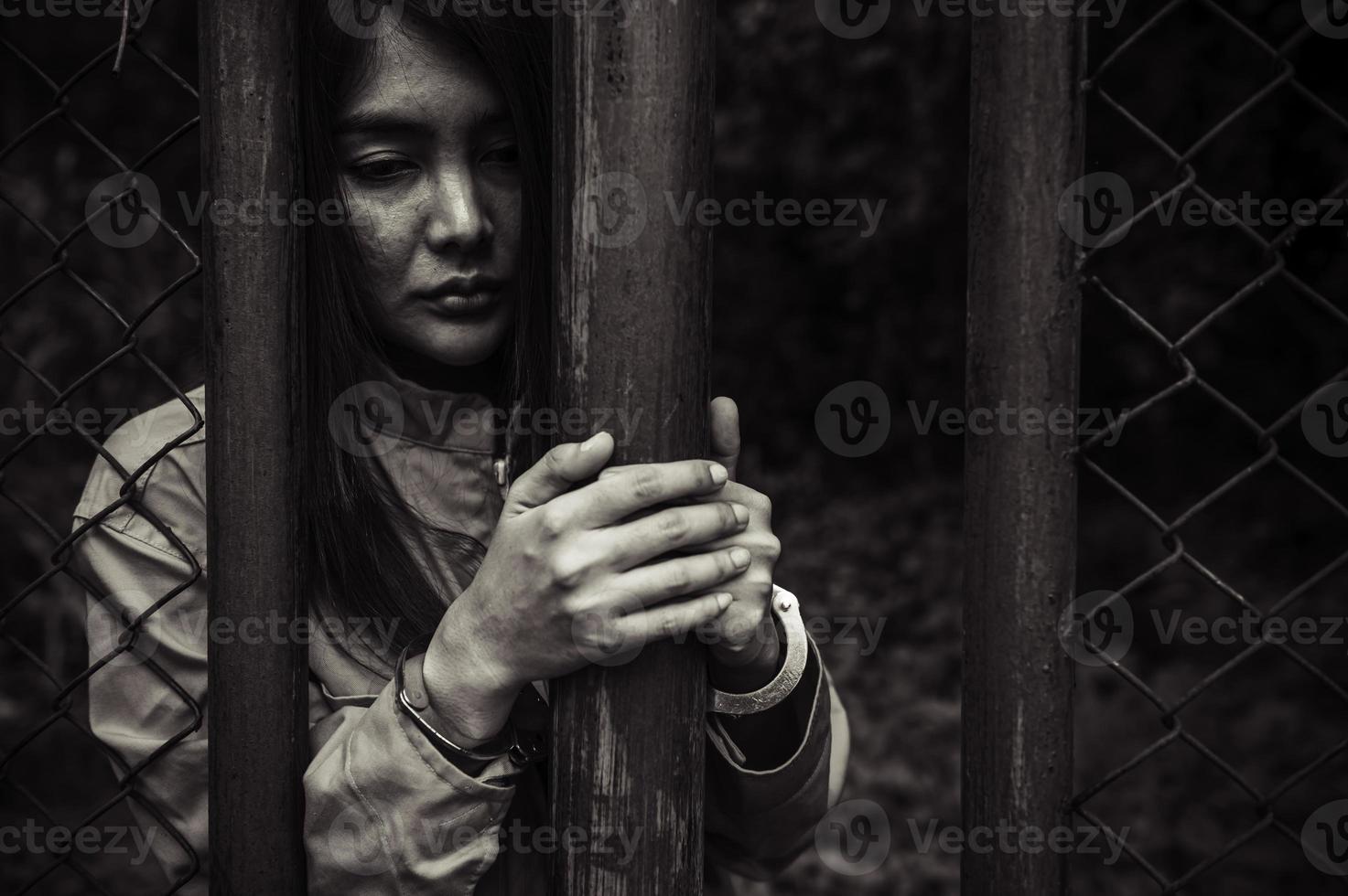 Portrait of women desperate to catch the iron prison,prisoner concept,thailand people,Hope to be free,If the violate the law would be arrested and jailed. photo