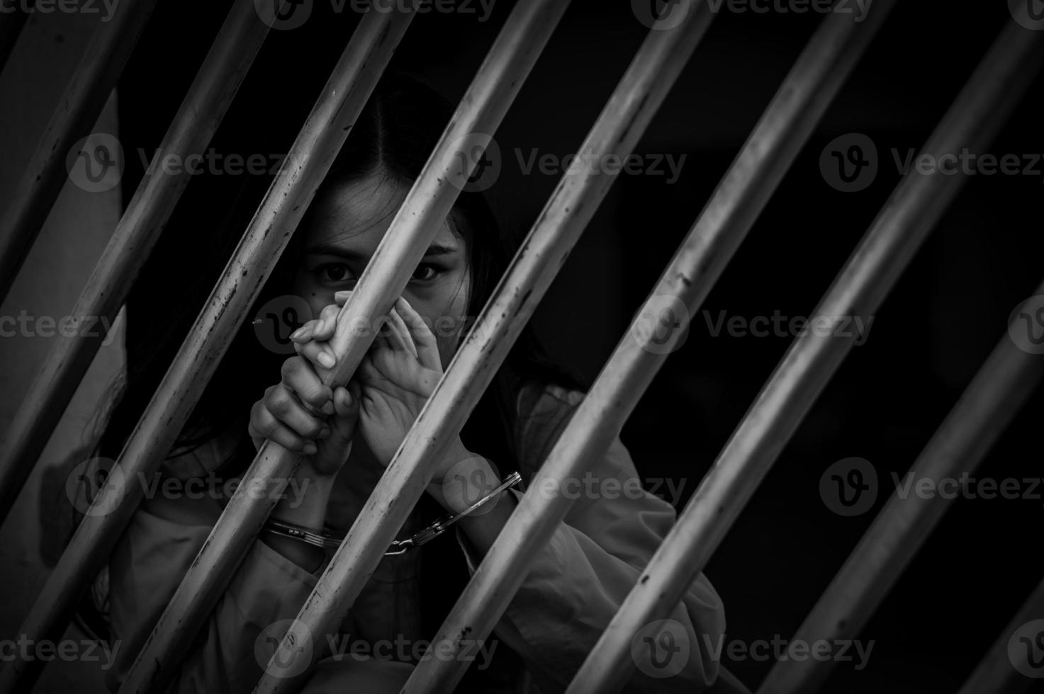 Portrait of women desperate to catch the iron prison,prisoner concept,thailand people,Hope to be free,If the violate the law would be arrested and jailed. photo