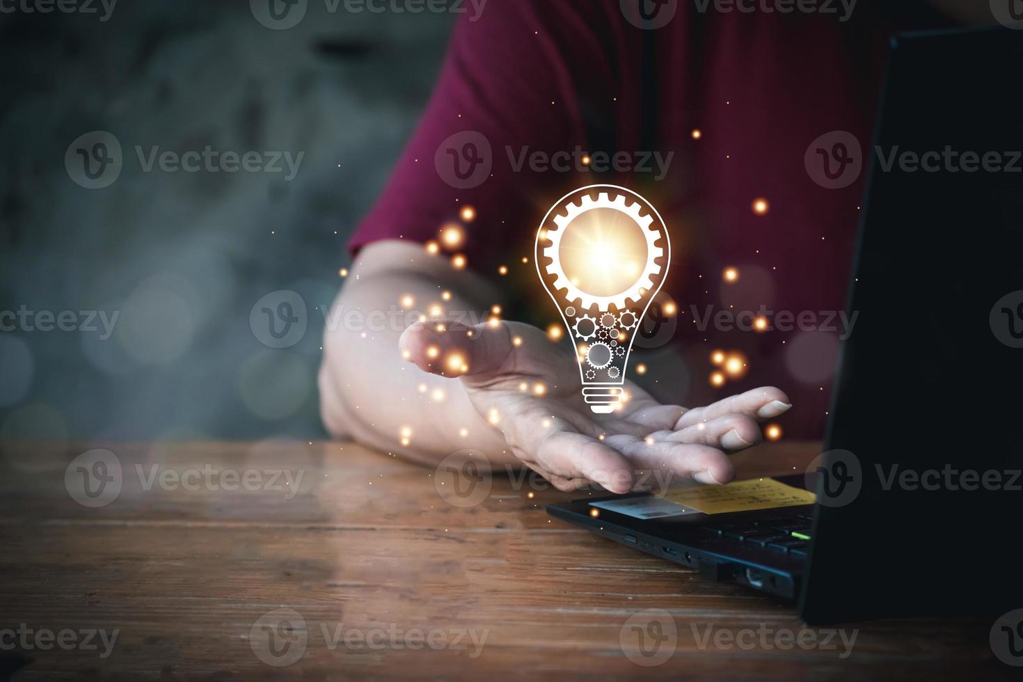 Businesswoman hand holding lightbulb with glowing light bulb on screen. Concept new. idea concept with innovation and inspiration, innovative technology in science and communication concept. photo