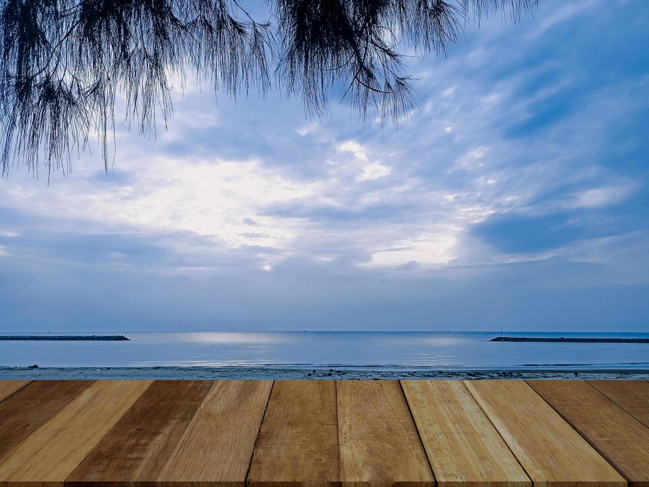 empty top of old wooded table and view of tropical beach and sky background. For present your products. photo